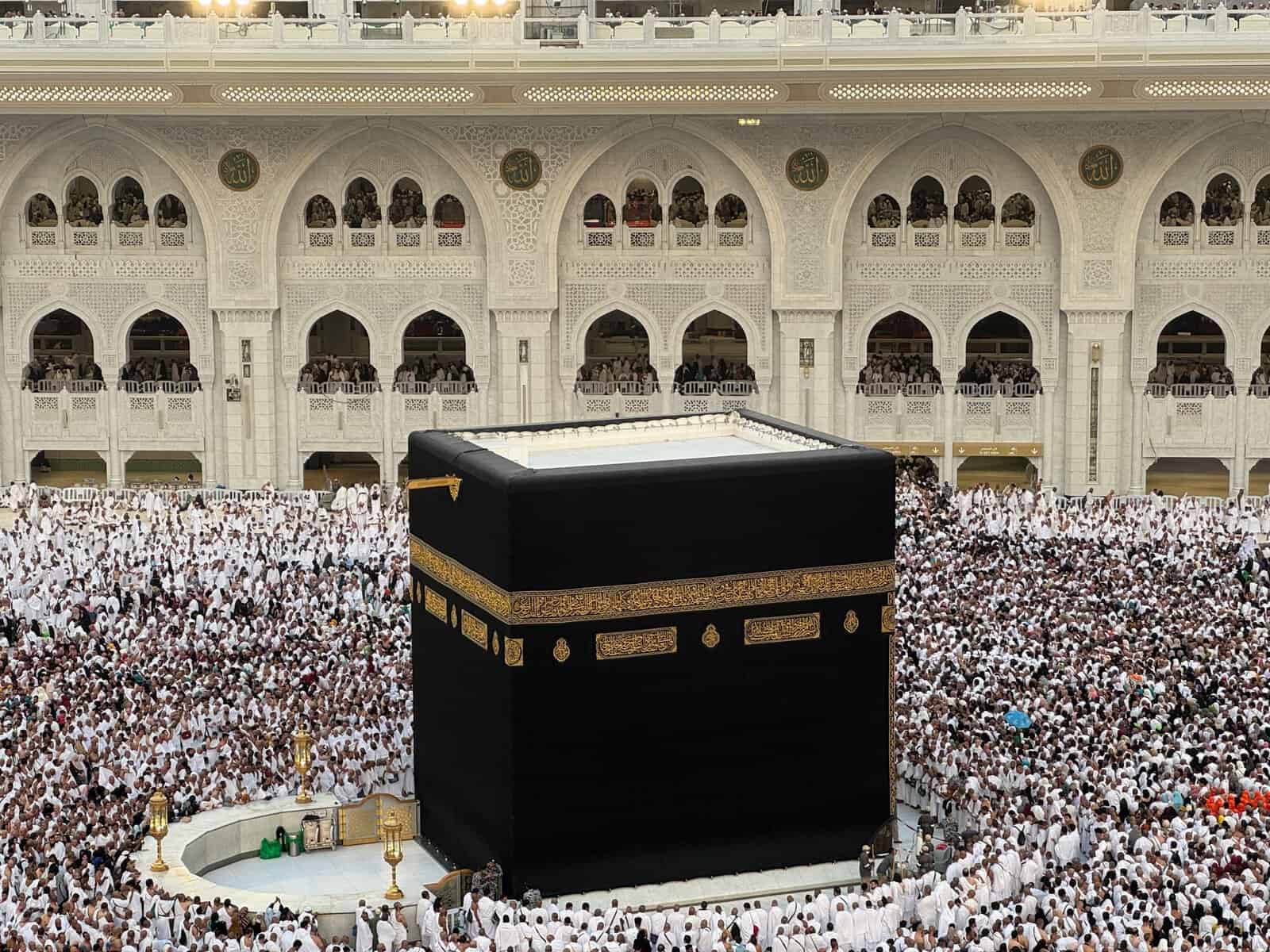 Aerial view of the Kaaba in Mecca surrounded by thousands of Hajj pilgrims in white Ihram during the Hajj season