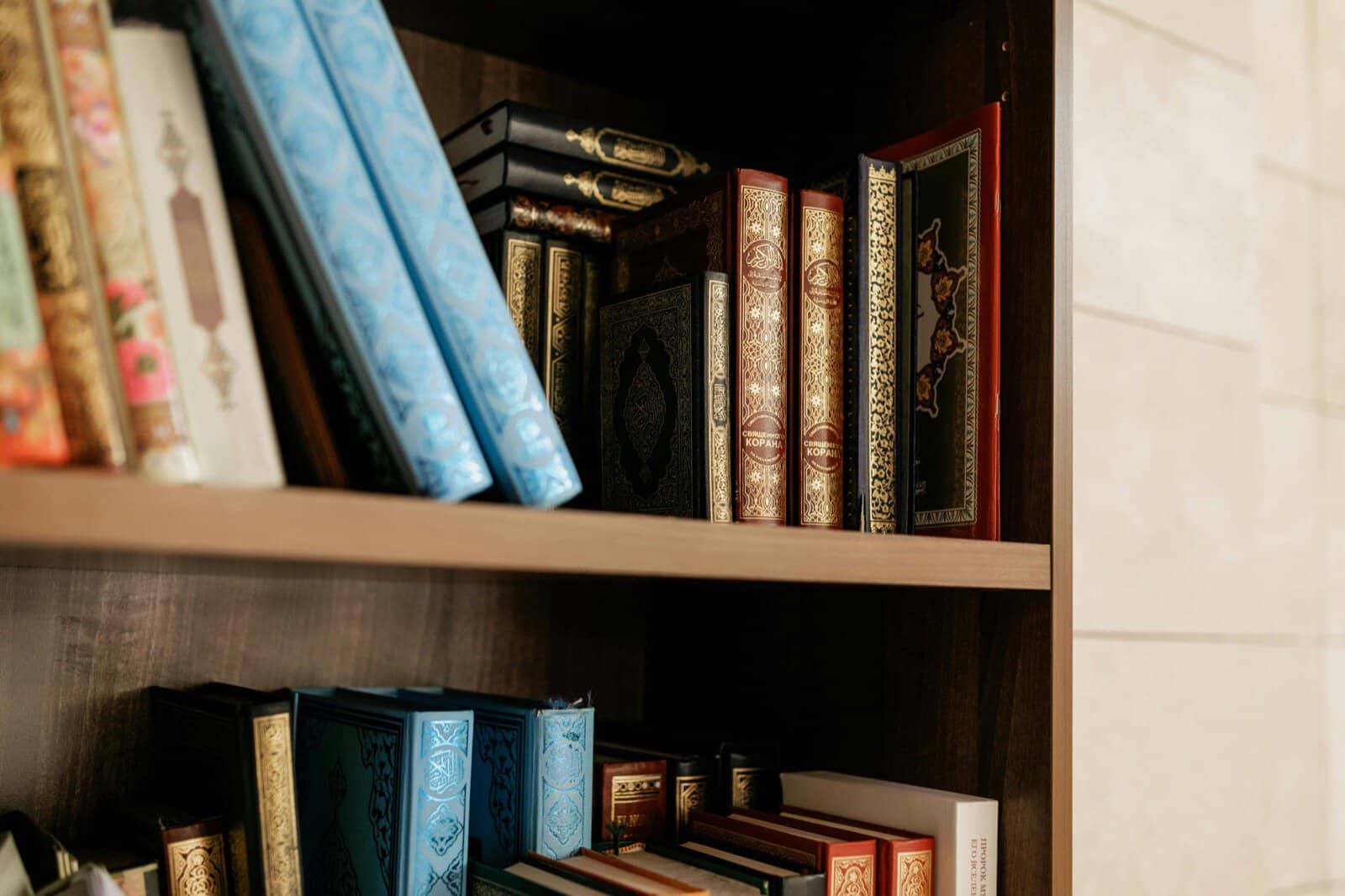A shelf of ornate Islamic books and Qurans, the kind of texts studied in an Islamic Studies programme