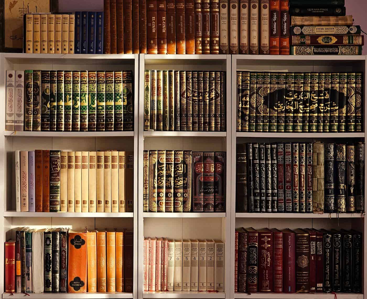 Shelves of multi-volume Arabic tafsir and hadith commentary sets in an Islamic library